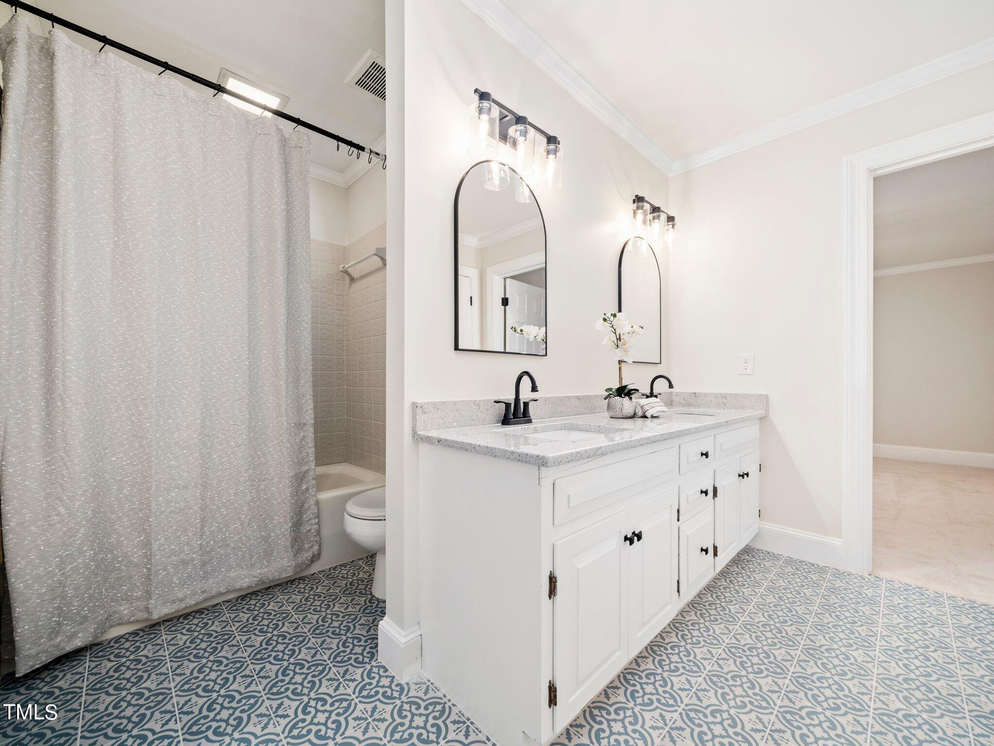 2900 Kenwick Court Raleigh, NC 27613 - Photo 23 of 34 a bathroom with a double vanity sink and a mirror
