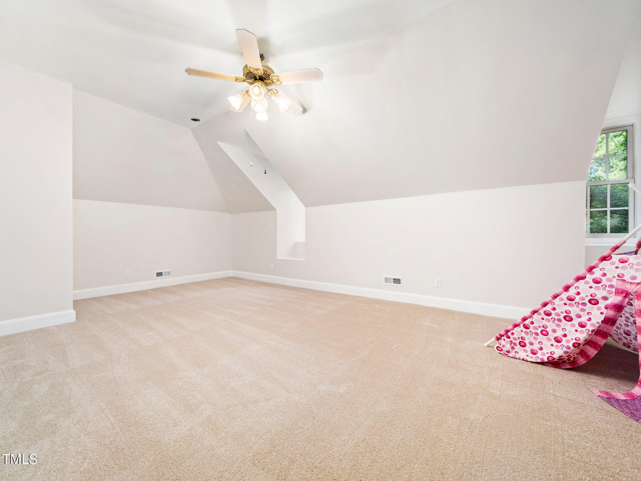 2900 Kenwick Court Raleigh, NC 27613 - Photo 24 of 34 a view of an empty room with a chandelier fan