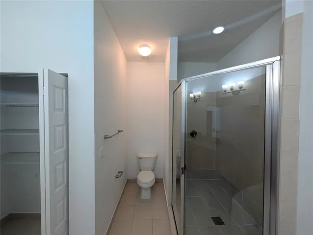 a bathroom with a glass door shower