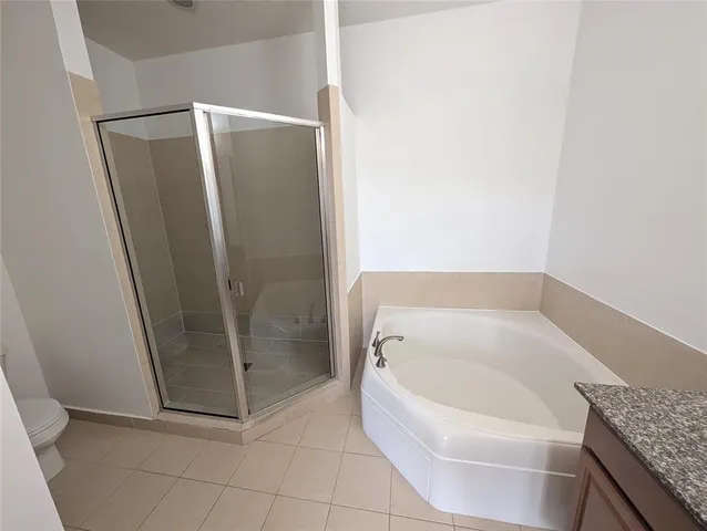 a bathroom with a granite countertop shower and a sink