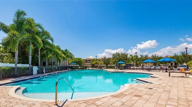 a swimming pool with outdoor seating and yard