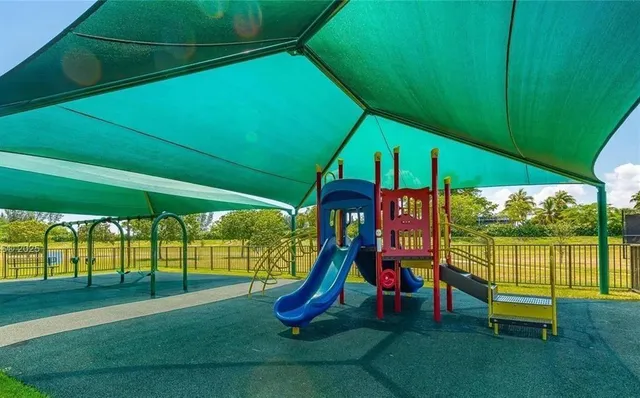 a view of park with a slide and floor