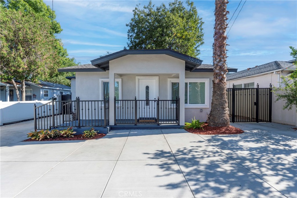 a view of a porch with furniture and floor to ceiling window