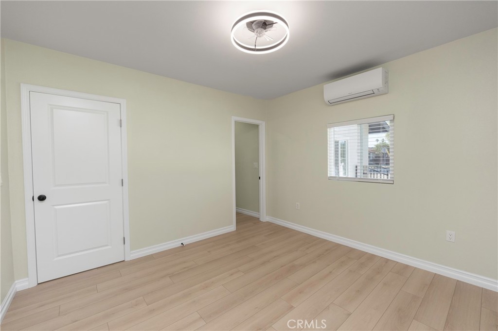 3895 Castleman Street Riverside, CA 92503 - Photo 11 of 22 an empty room with wooden floor and windows