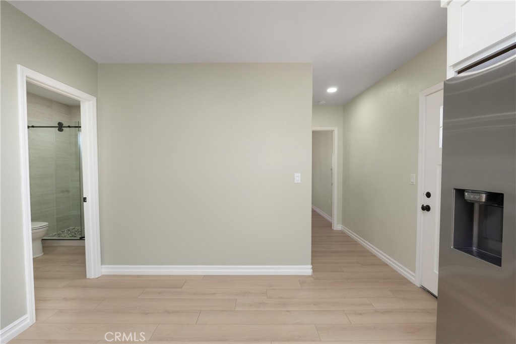 3895 Castleman Street Riverside, CA 92503 - Photo 14 of 22 an empty room with wooden floor and entrance