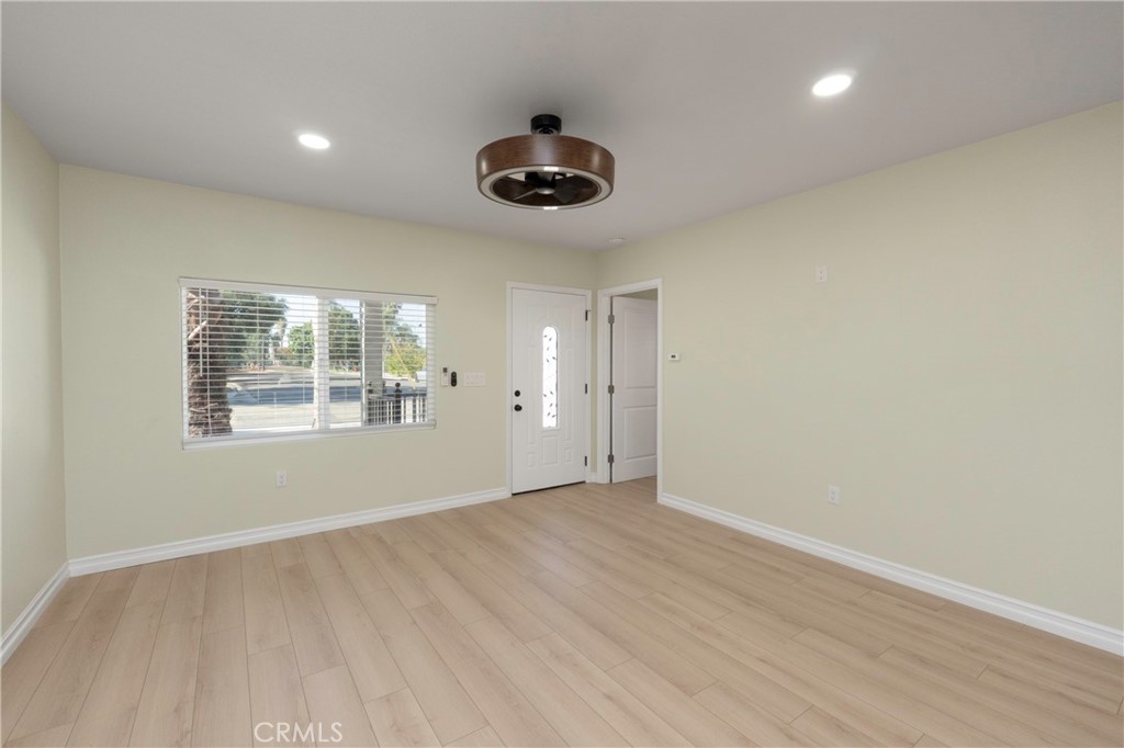 3895 Castleman Street Riverside, CA 92503 - Photo 15 of 22 an empty room with wooden floor and windows