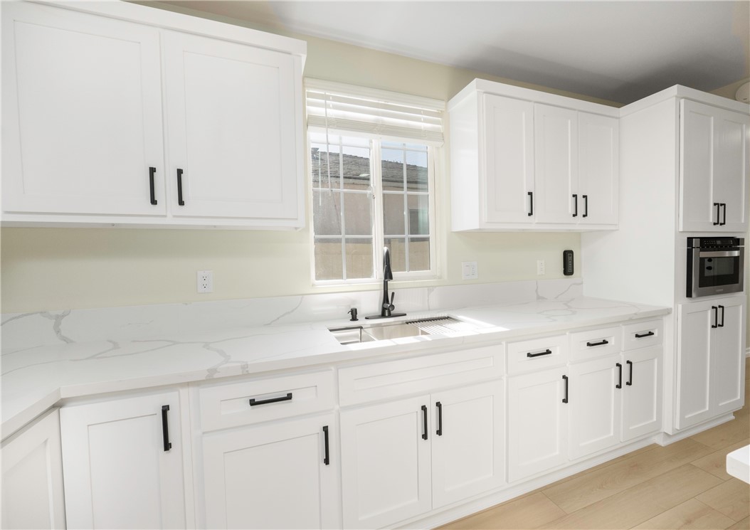 3895 Castleman Street Riverside, CA 92503 - Photo 5 of 22 a kitchen with stainless steel appliances white cabinets and a window
