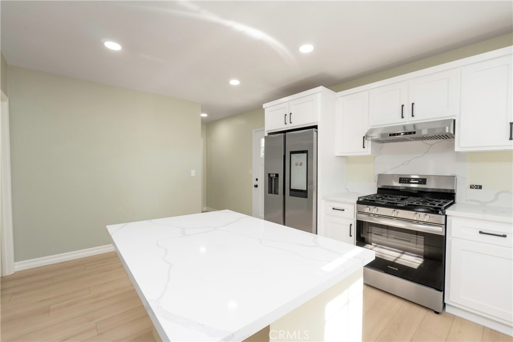 3895 Castleman Street Riverside, CA 92503 - Photo 6 of 22 a kitchen with stainless steel appliances a stove a refrigerator and cabinets