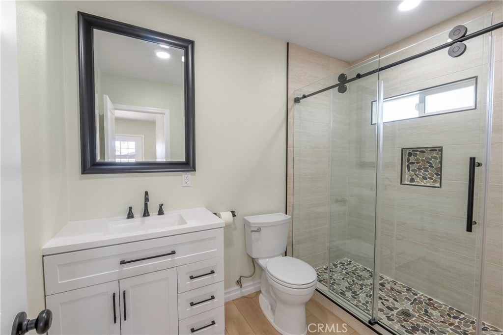 3895 Castleman Street Riverside, CA 92503 - Photo 9 of 22 a bathroom with a shower sink vanity mirror and toilet