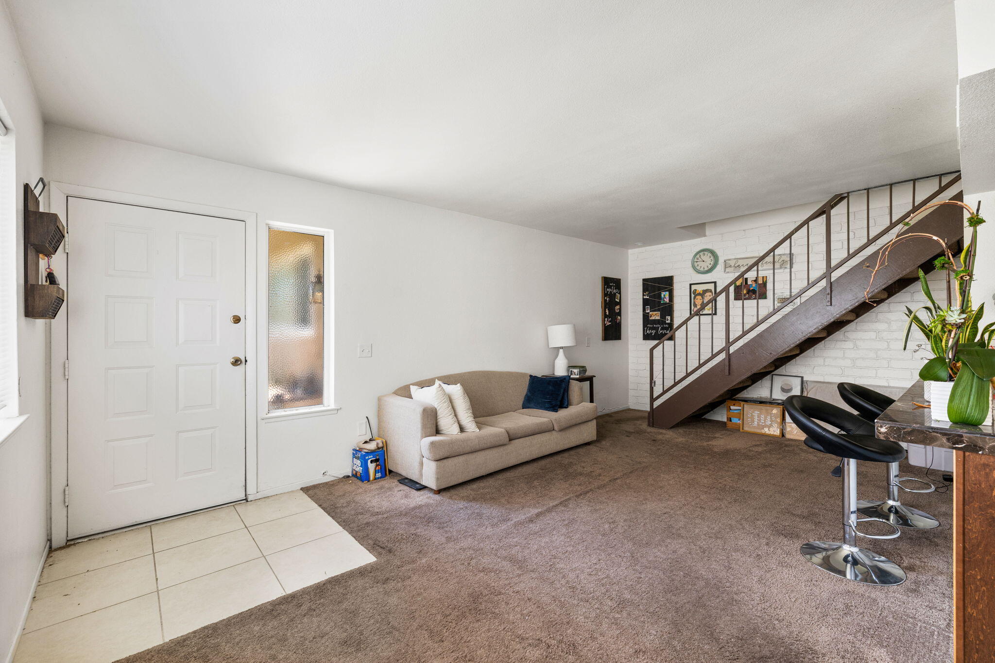 72632 Raven Road, Unit 2 Palm Desert, CA 92260 - Photo 3 of 30 a living room with furniture and stairs