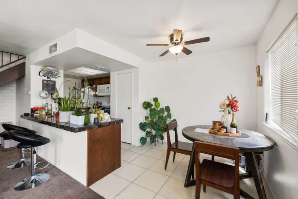a dining room with furniture and window