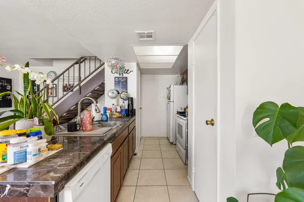 a hallway with a dining table and chairs