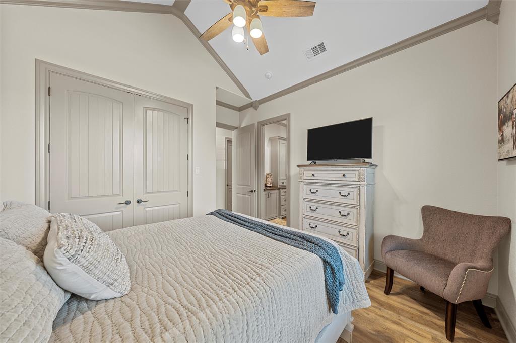 18503 Wortham Bend Road China Spring, TX 76633 - Photo 18 of 40 a bedroom with a bed a flat screen tv and a couch