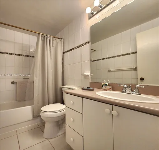 a bathroom with a double vanity sink toilet and shower