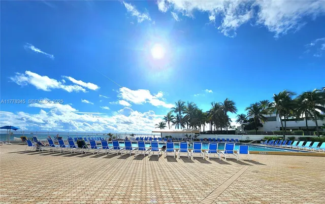 a view of a swimming pool with seating area