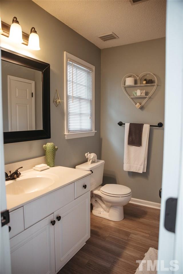7020 Epping Forest Drive Raleigh, NC 27613 - Photo 13 of 29 a bathroom with a sink a toilet and mirror