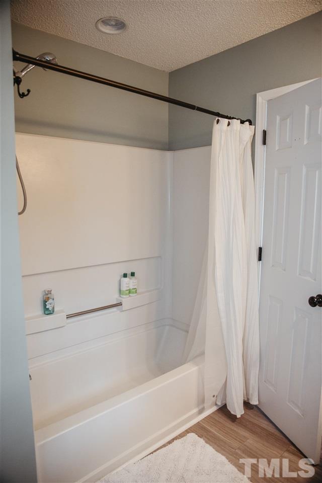 7020 Epping Forest Drive Raleigh, NC 27613 - Photo 14 of 29 a bathroom with a shower and a bath tub