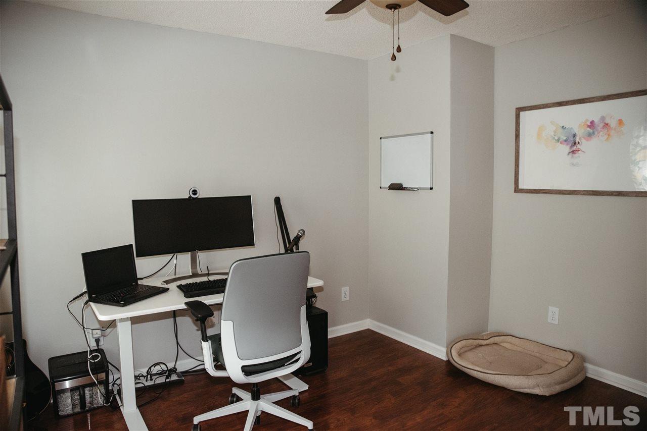 7020 Epping Forest Drive Raleigh, NC 27613 - Photo 16 of 29 a view of a workspace with furniture and wooden floor