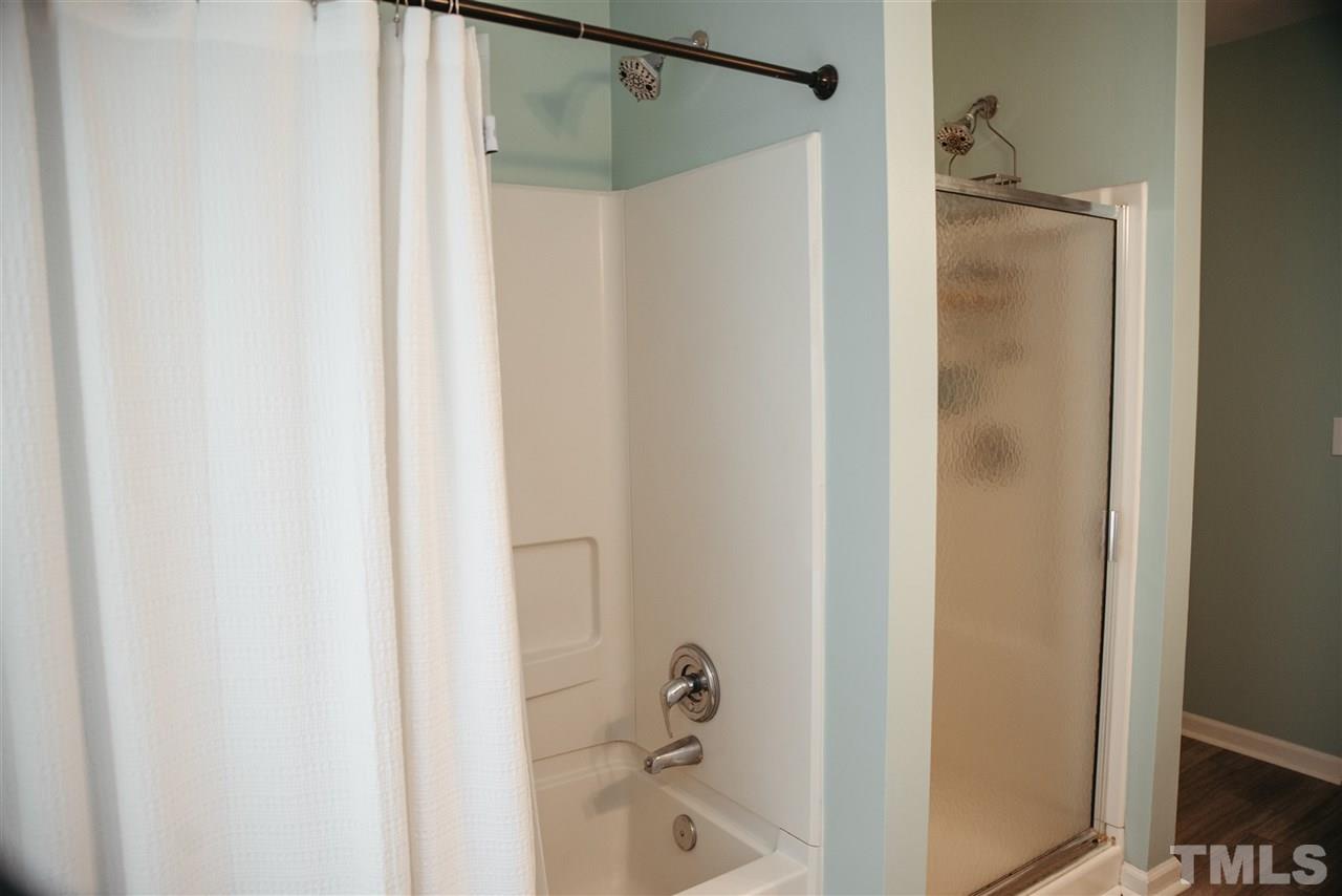 7020 Epping Forest Drive Raleigh, NC 27613 - Photo 18 of 29 a bathroom with a shower and a bath tub