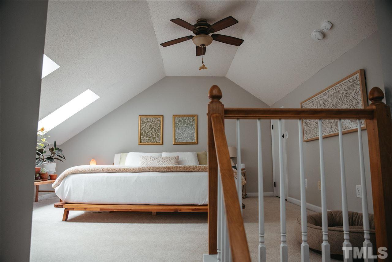 7020 Epping Forest Drive Raleigh, NC 27613 - Photo 21 of 29 a bedroom with a bed and a ceiling fan