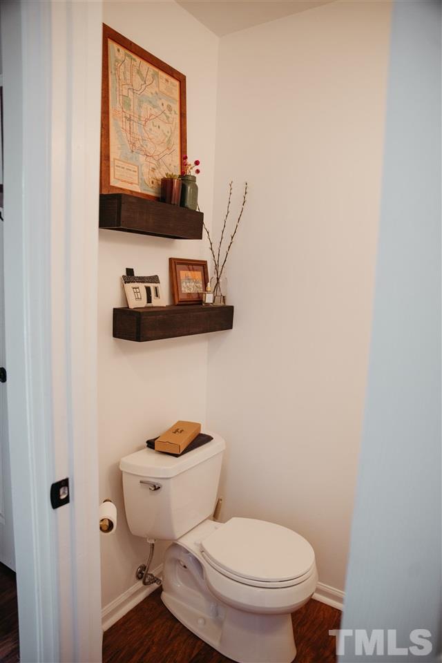 7020 Epping Forest Drive Raleigh, NC 27613 - Photo 9 of 29 a white toilet sitting next to a bathroom sink