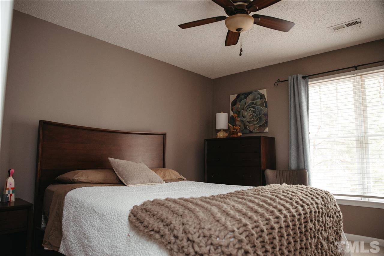 7020 Epping Forest Drive Raleigh, NC 27613 - Photo 10 of 29 a bedroom with a bed and a window