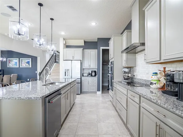 a living room with a chandelier furniture and a window