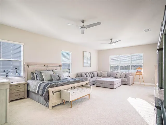 a bathroom with a white toilet sitting next to a white tub and shower