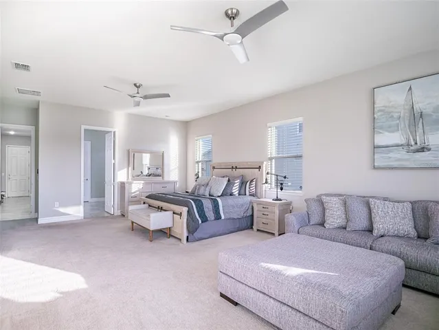 a bedroom with a bed and large window