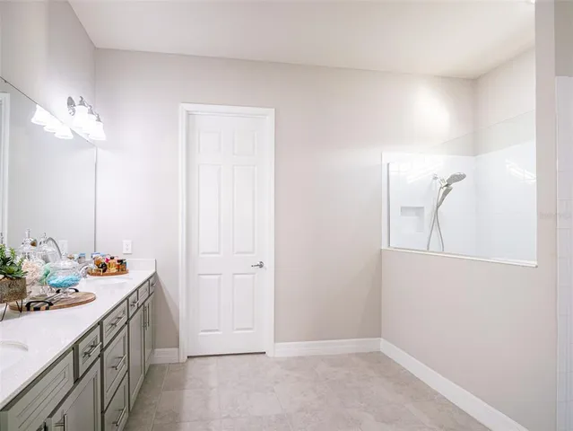 a bedroom with a bed and a ceiling fan