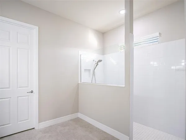 a spacious bathroom with a double vanity sink a mirror and a shower