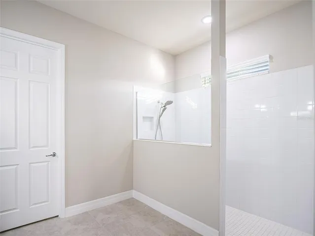 a spacious bathroom with a double vanity sink a mirror and a shower