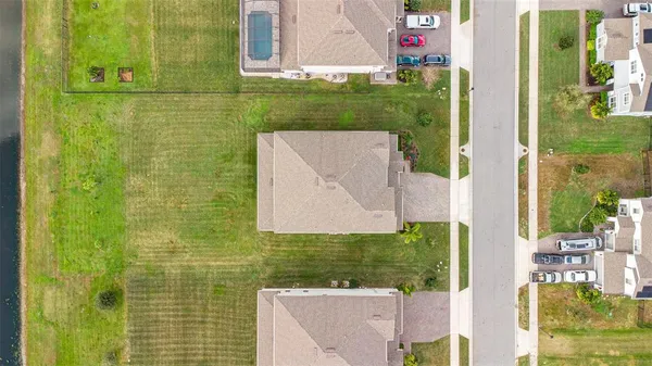an aerial view of a house with a yard