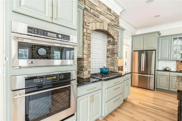 a kitchen with a stove and a refrigerator