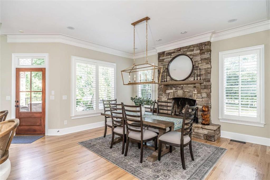 138 Nelson Boulevard Northwest Rome, GA 30165 - Photo 13 of 39 a dining room with furniture a fireplace and wooden floor