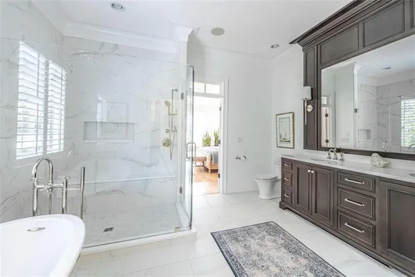 a bathroom with a tub a sink shower and mirror