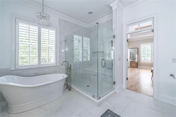 a white bath tub sitting next to a shower