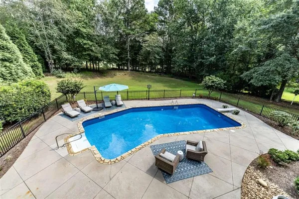 a view of a swimming pool with lounge chair
