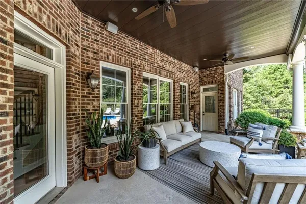 a balcony with furniture and potted plants