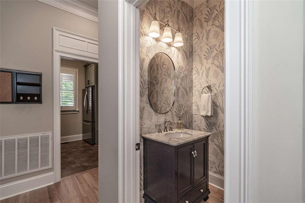 138 Nelson Boulevard Northwest Rome, GA 30165 - Photo 24 of 39 a bathroom with a sink a mirror and vanity