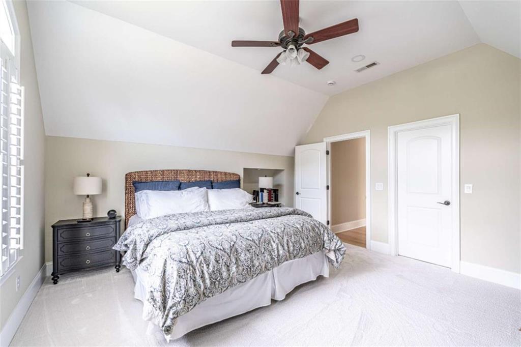 138 Nelson Boulevard Northwest Rome, GA 30165 - Photo 29 of 39 a bedroom with a large bed and a chandelier