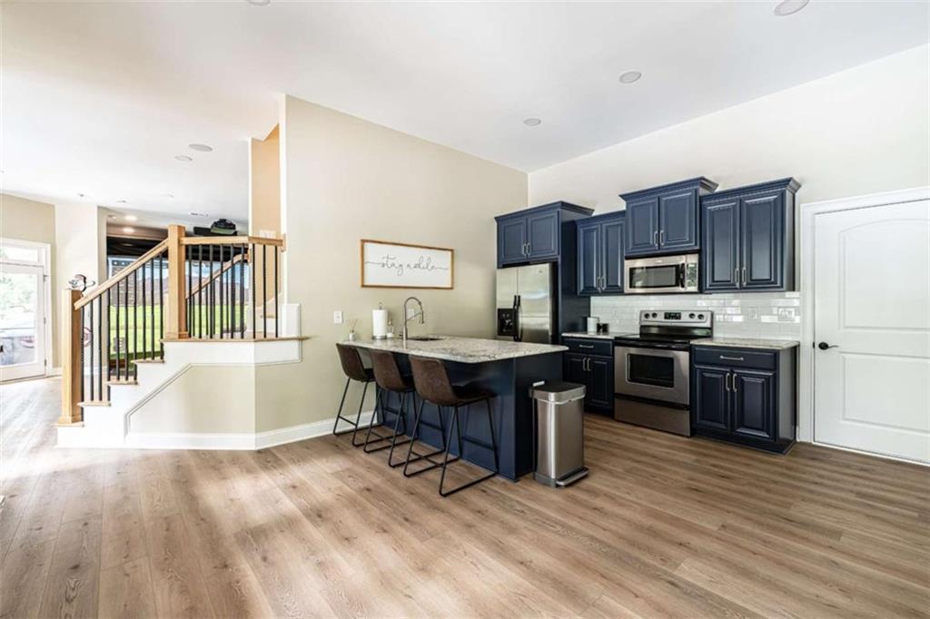 138 Nelson Boulevard Northwest Rome, GA 30165 - Photo 34 of 39 a kitchen with a sink cabinets and wooden floor
