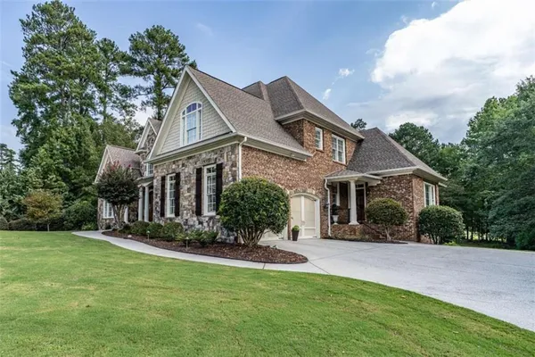a front view of house with yard and green space