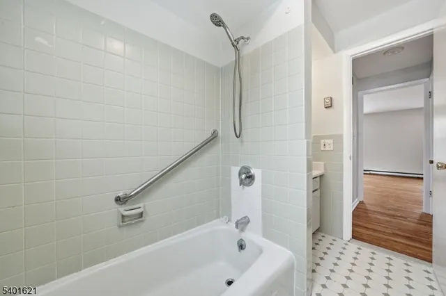 a bathroom with a bathtub and shower