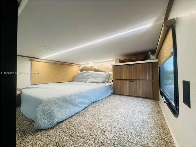 a view of an chairs and table in the room