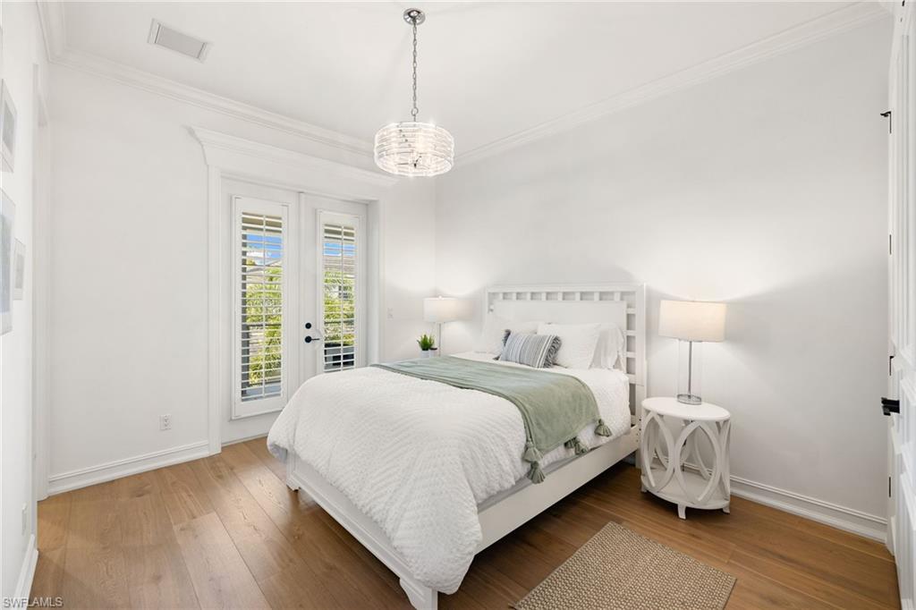 950 8th Street South Naples, FL 34102 - Photo 13 of 21 a spacious bedroom with a bed and a window