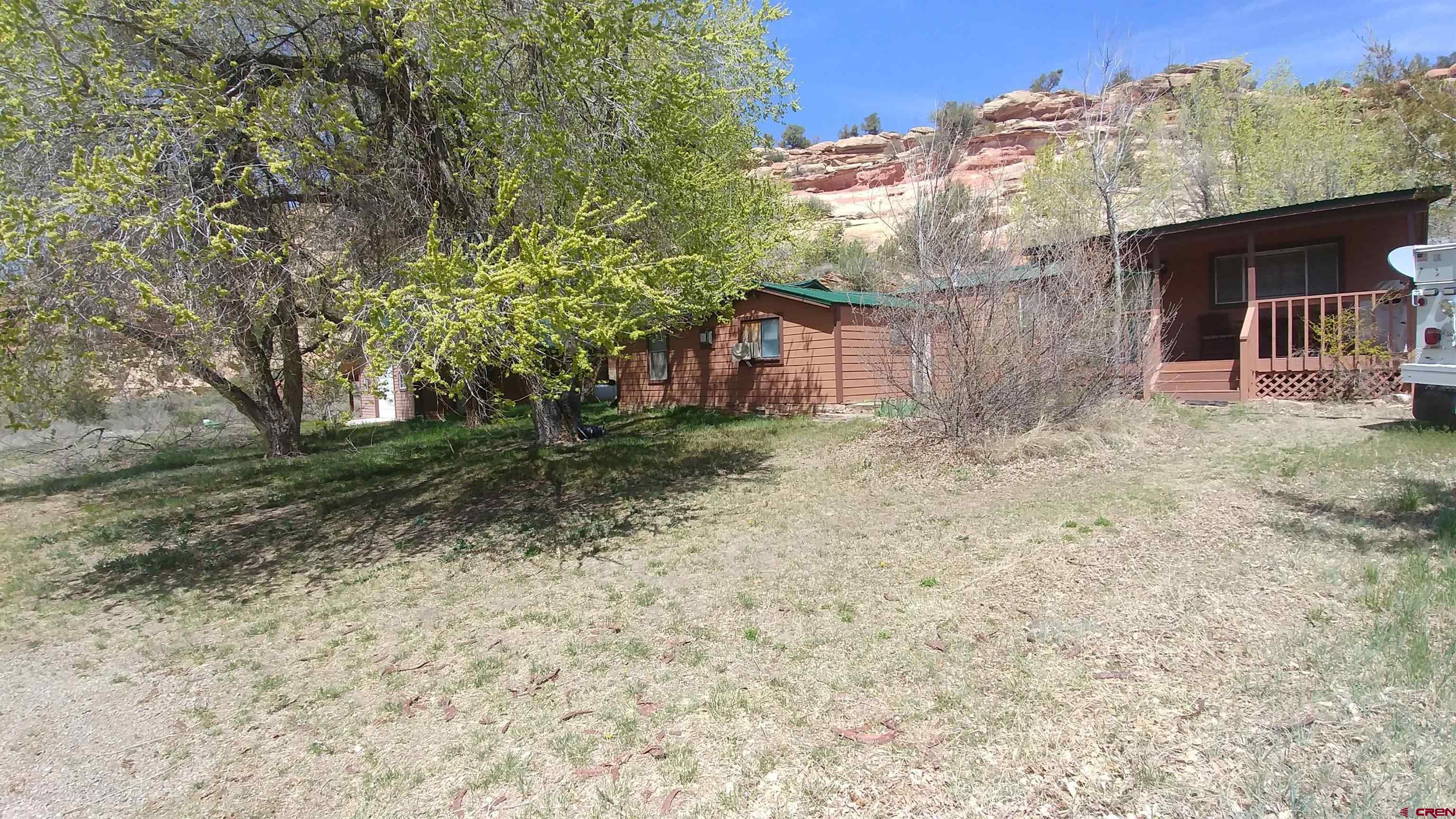 15705 Rd J Cortez, CO 81321 - Photo 4 of 34 a backyard of a house with lots of green space