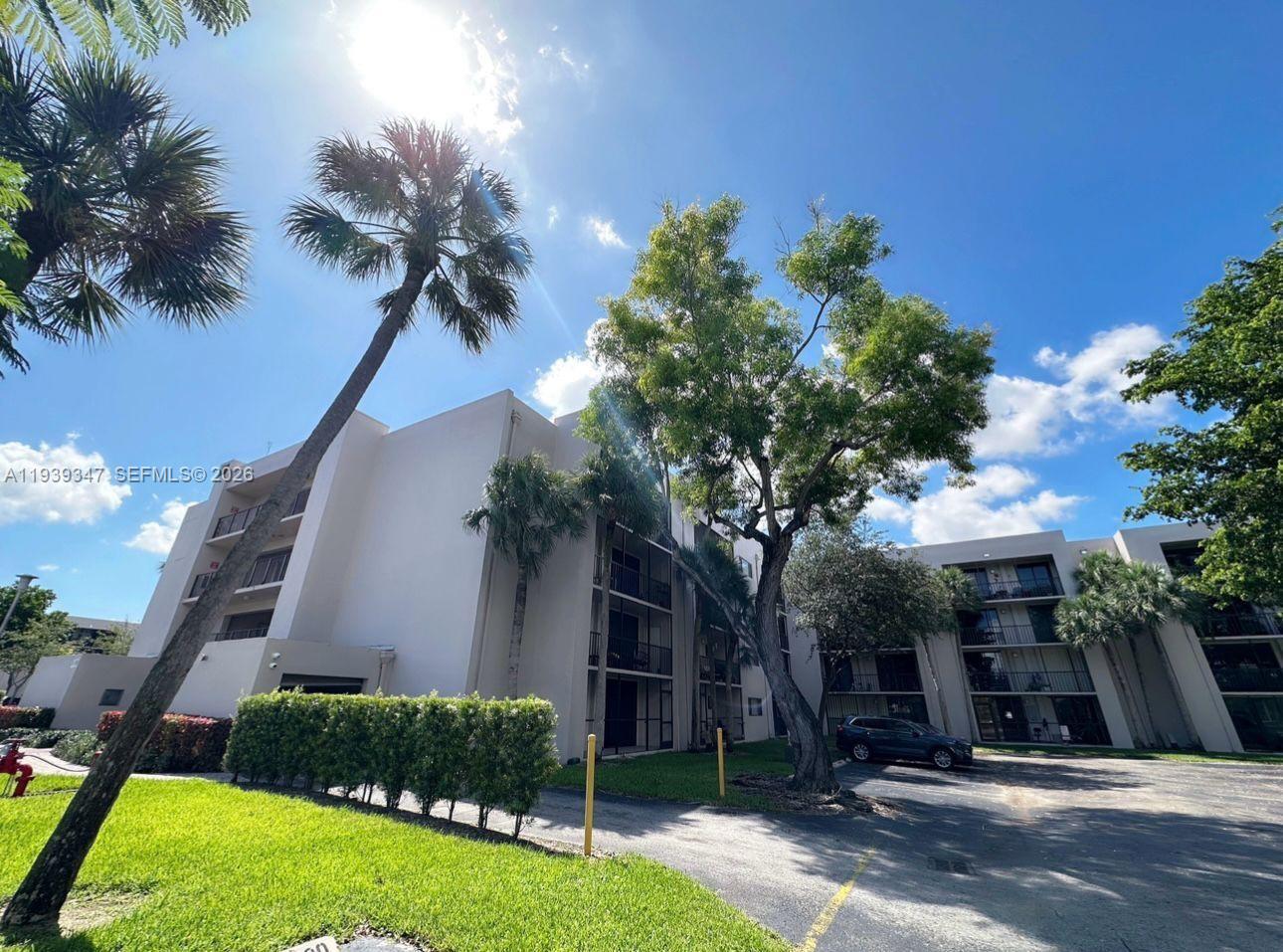8540 Southwest 133rd Avenue Road, Unit 312 Miami, FL 33183 - Photo 15 of 15 a front view of a house with a yard