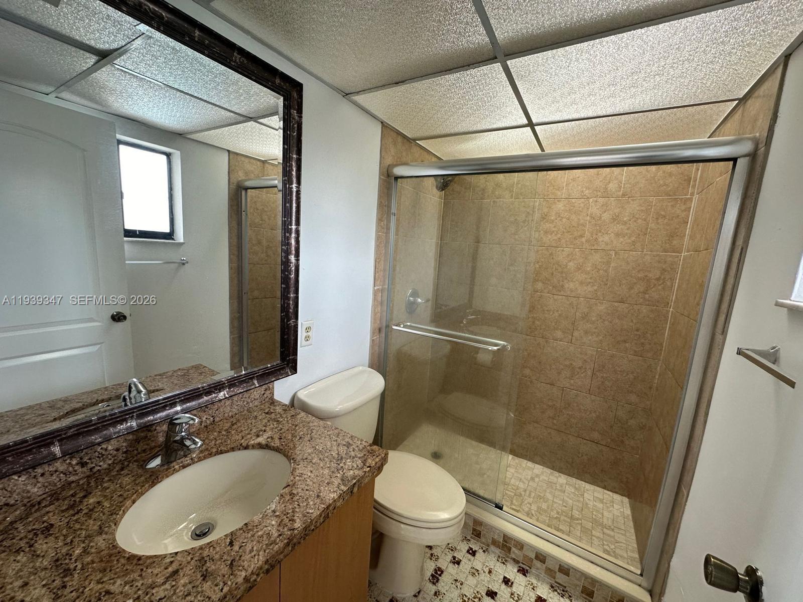 8540 Southwest 133rd Avenue Road, Unit 312 Miami, FL 33183 - Photo 9 of 15 a bathroom with a sink toilet and shower