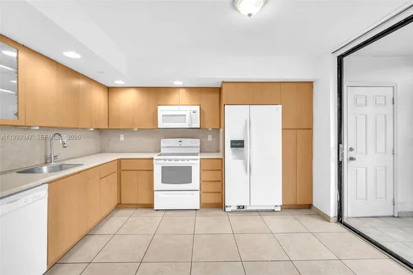 a kitchen with a sink cabinets and appliances